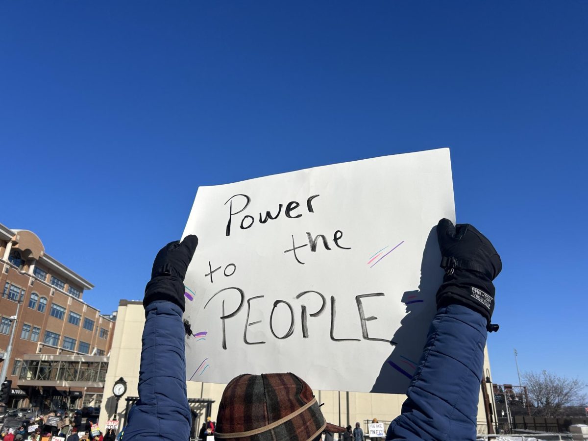 A protestor holds up a sign reading “power to the people” at the protest on Jan. 25th.
